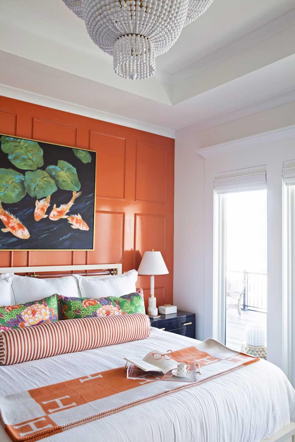 Orange wall in luxury-designed bedroom