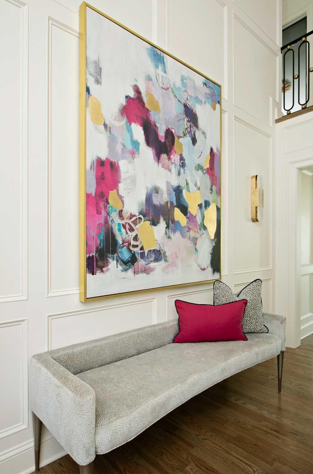 Modern bench below painting in luxury-designed home